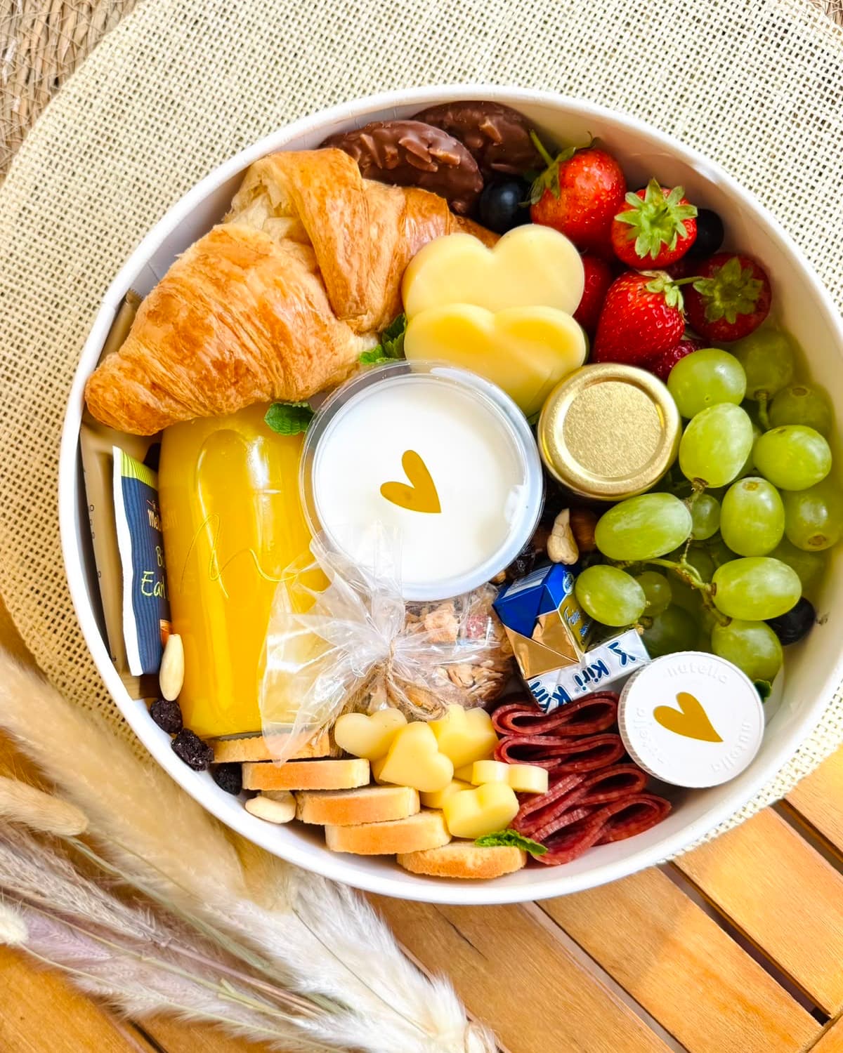 Geöffnete Frühstücksbox Unforgettable Momentum S mit Croissant, Obst und Joghurt